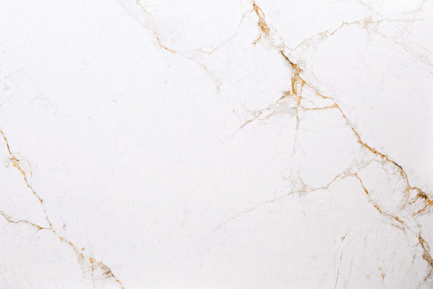 Abu Dhabi Bianco Porcelain close-up showing a bright white base with fine warm gold veining