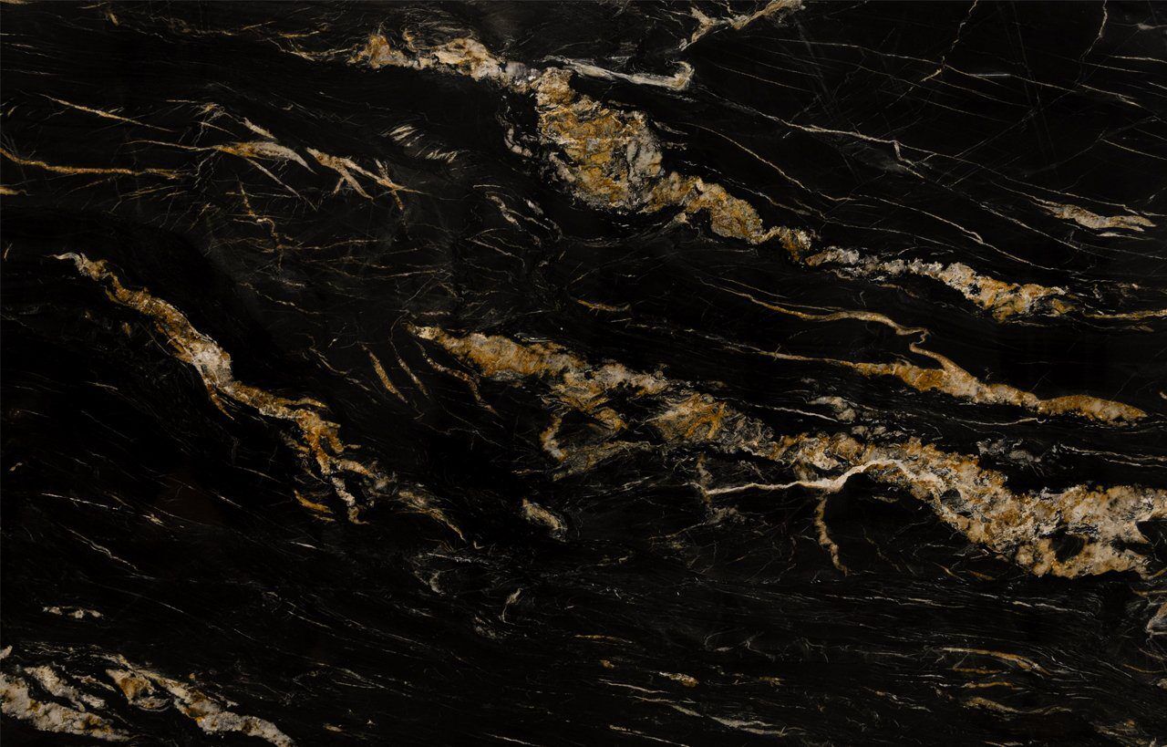 Close up slab photo of African Fusion Granite showing dramatic gold veining and layered movement across a deep black stone background.