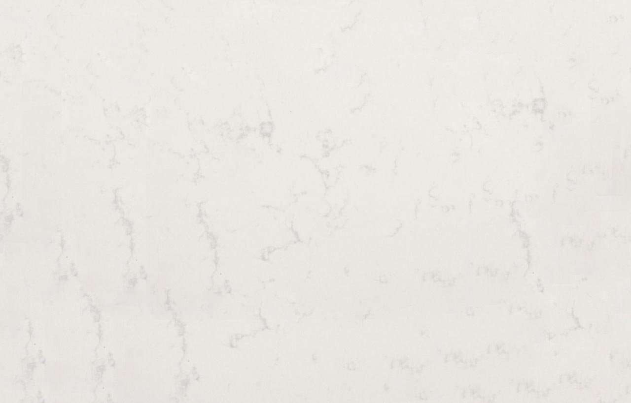 Close up of Carrara Quartz surface showing soft white background and light grey veining