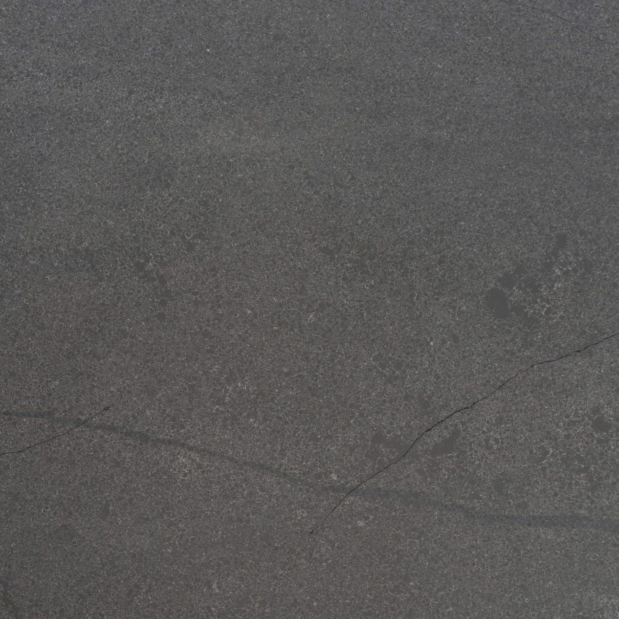 Charcoal Grey Porcelain slab close-up showing fine grain texture and faint veining across a dark surface
