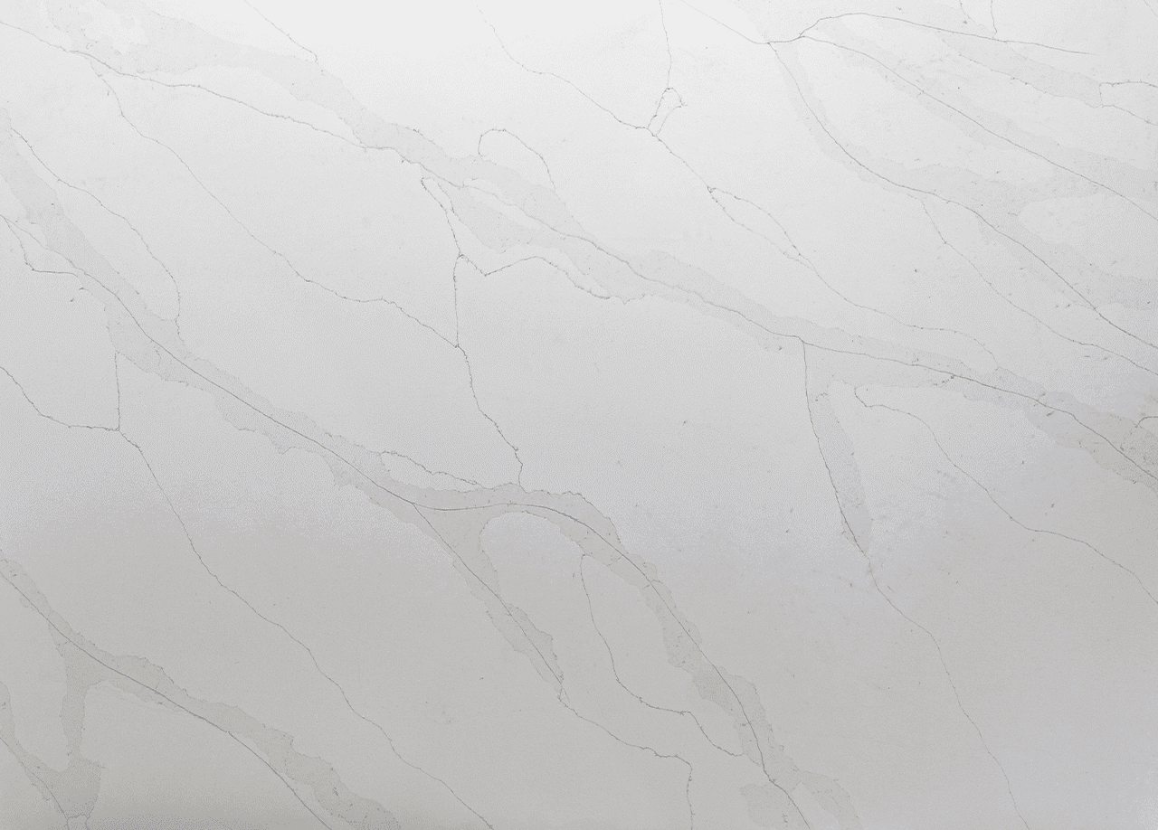 Quartz slab close-up with pale white background and soft grey marble-effect veining flowing across the surface