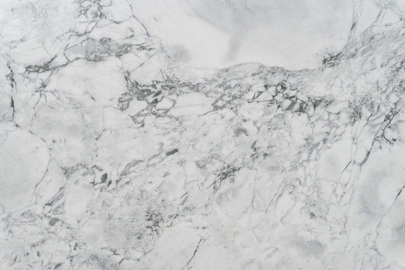 Calacatta Super White Porcelain close-up showing a bright white base with clustered grey veining and soft clouded shading