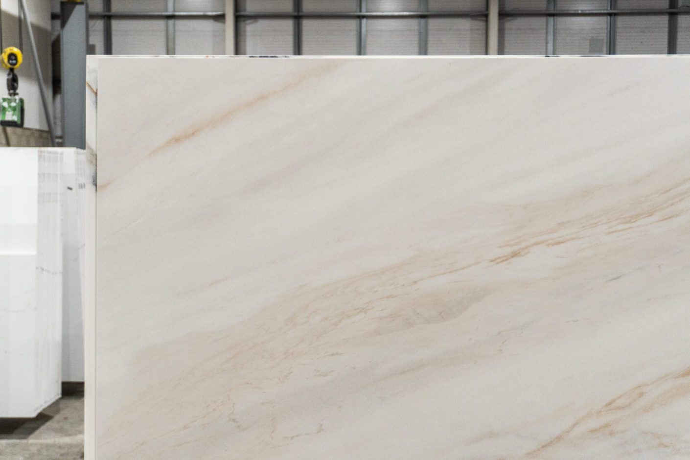 Fusion Gold Porcelain slab section showing fine warm veining and subtle cloudy movement on a light background