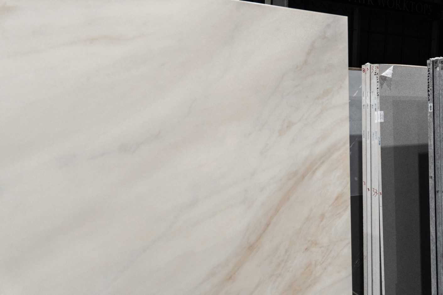 Fusion Gold Porcelain slab close-up with soft beige veining sweeping diagonally across a pale base