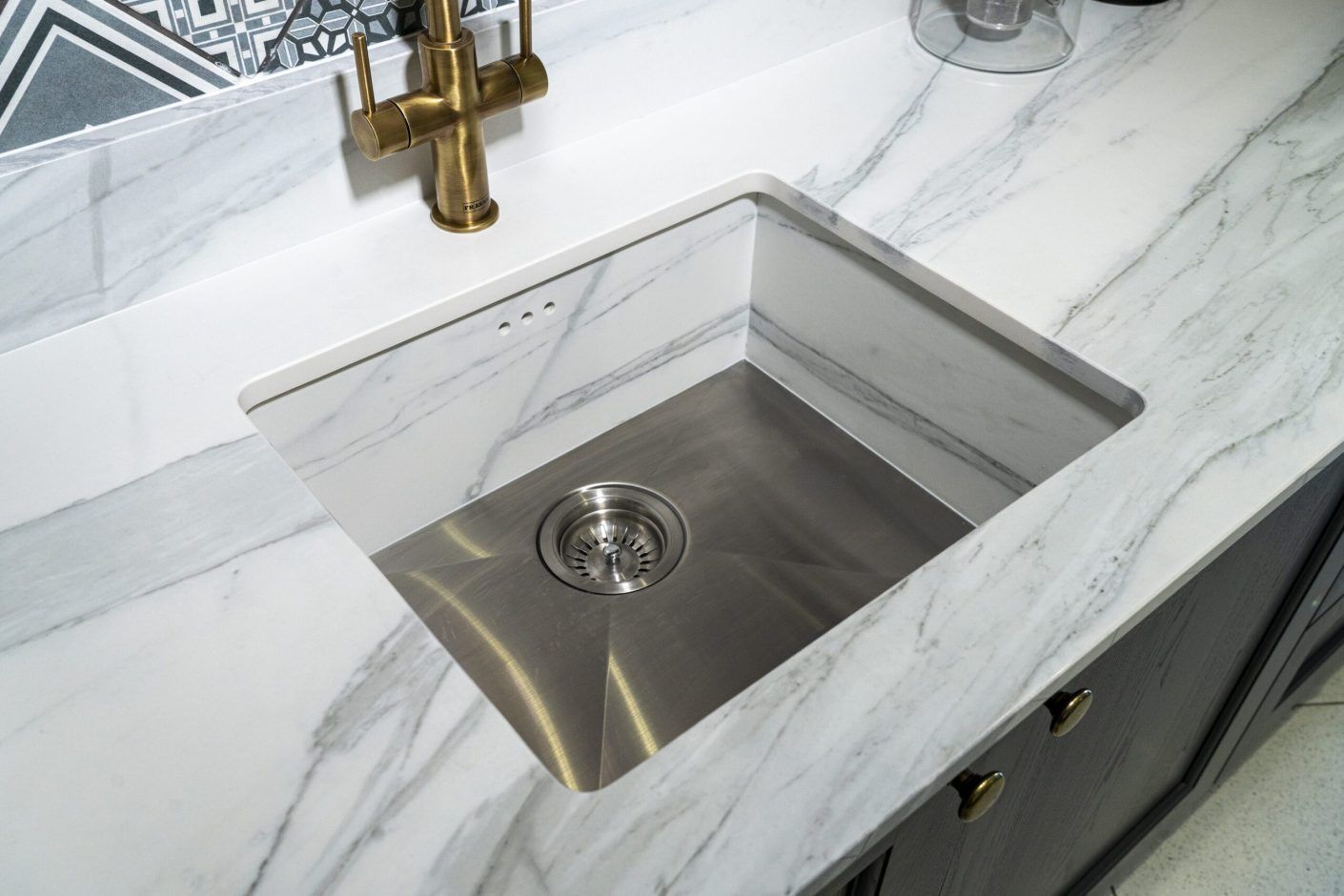 Bianco Lasa Porcelain sink detail showing polished undermount bowl and veining across the worktop