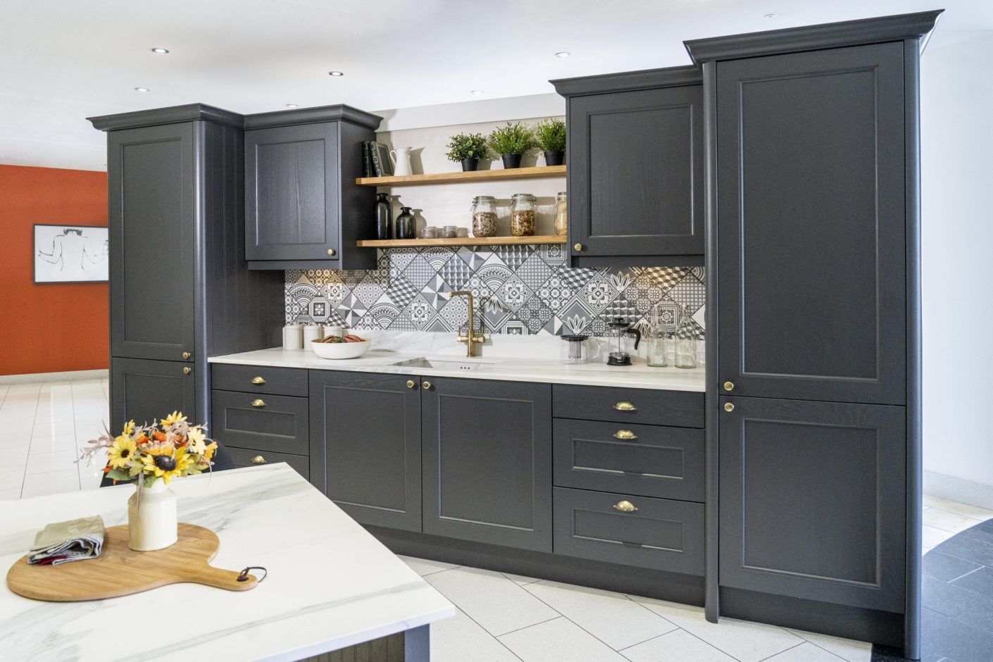 Bianco Lasa Porcelain upstand and splashback with veining above dark cabinetry and brass handles