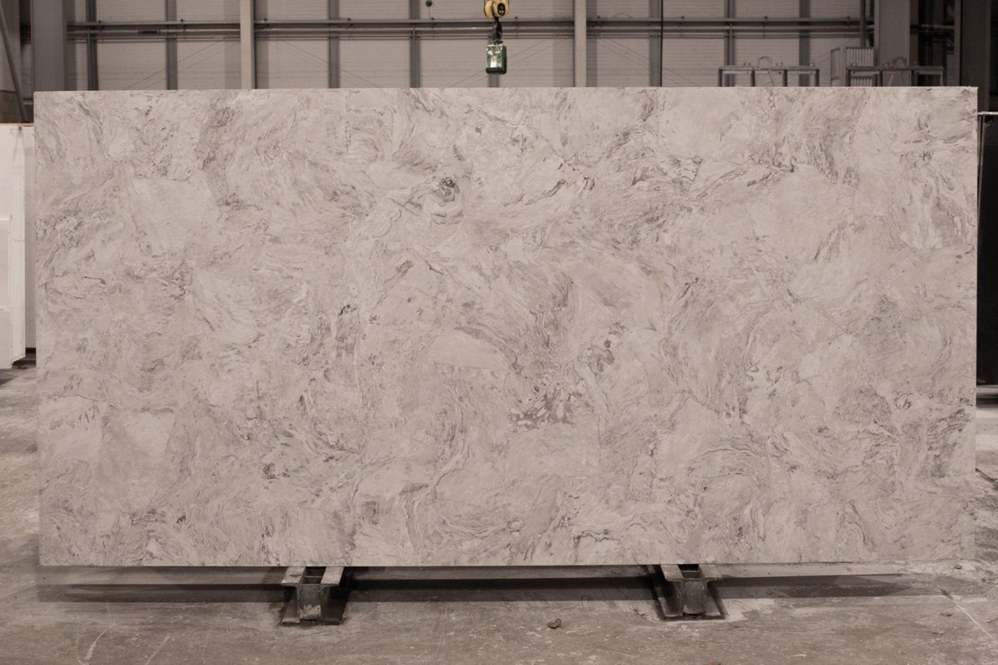 Ivory Drift Quartz full slab standing in the workshop showing large-scale stone-effect movement across the surface