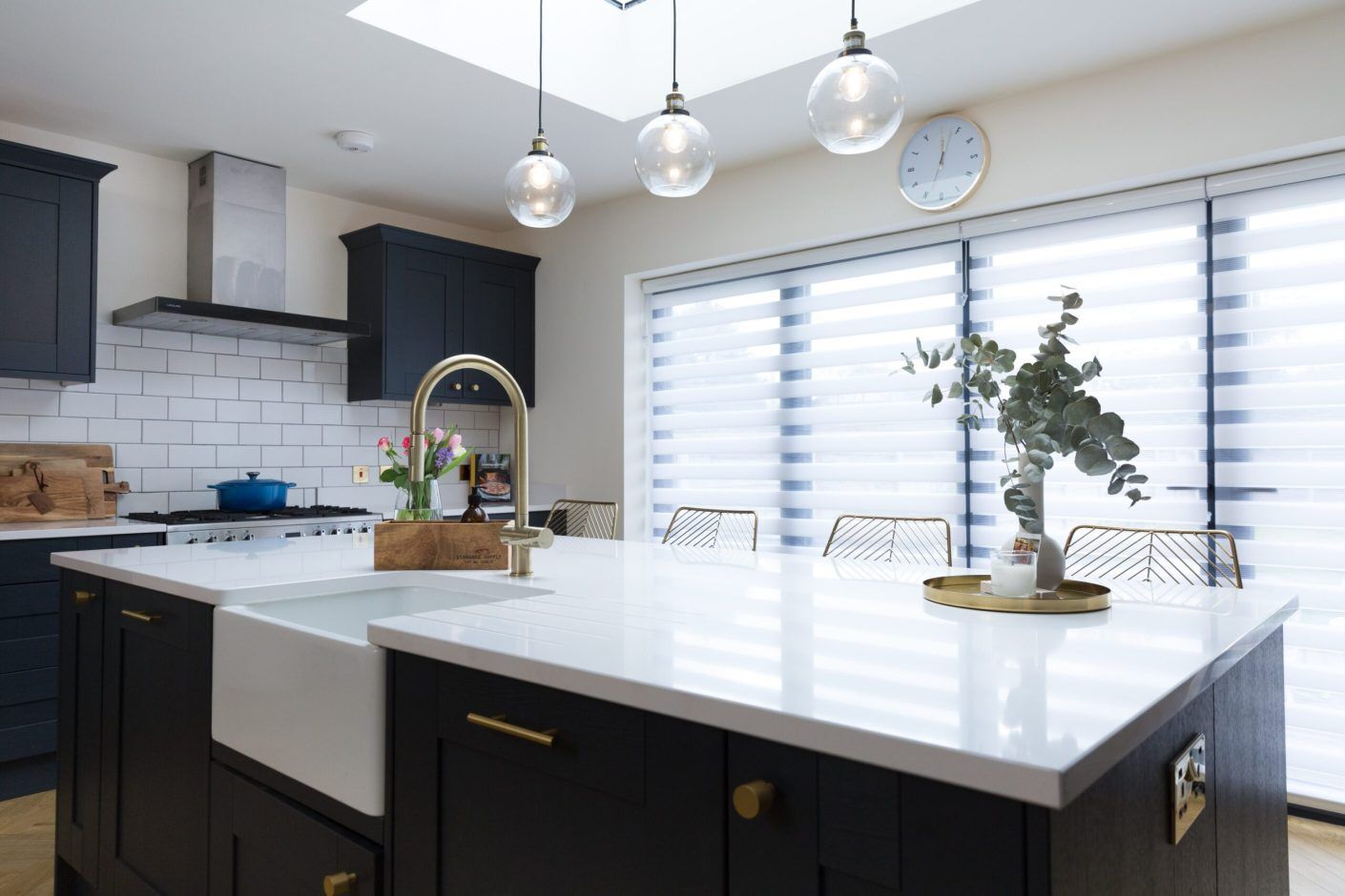 Blanco Zeus Quartz island worktop with bright white surface and brass tap in a modern kitchen