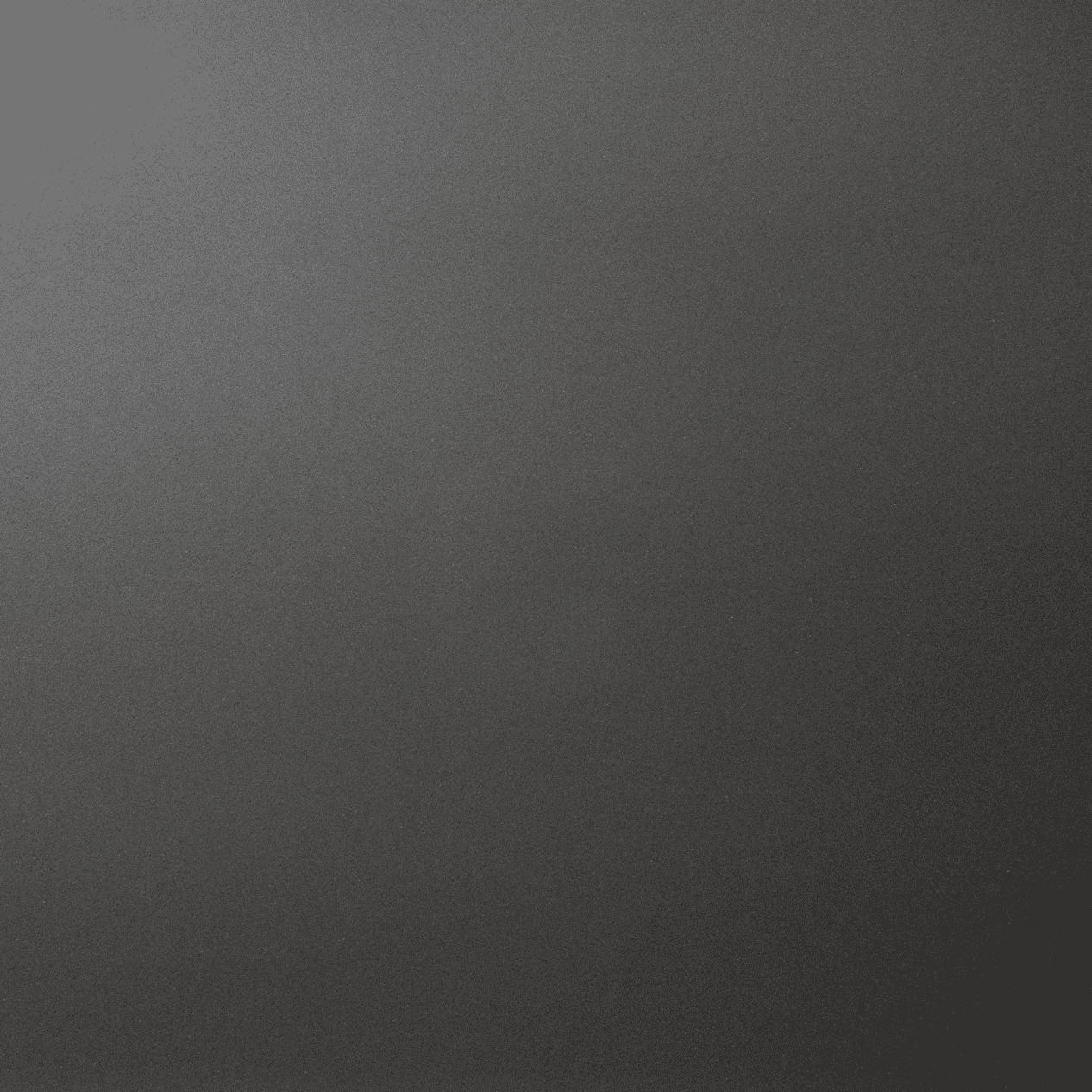 Marengo Quartz slab close-up showing a smooth dark grey surface with a uniform, matte-style finish