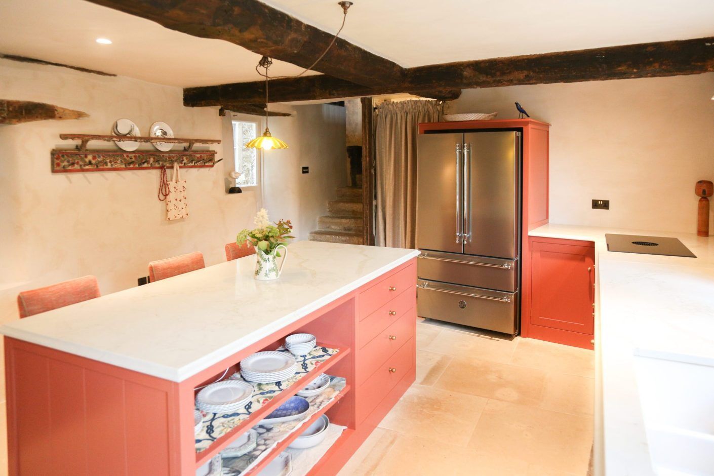 Supreme Calacatta Quartz island worktop in a traditional kitchen showing bright white surface on red base units