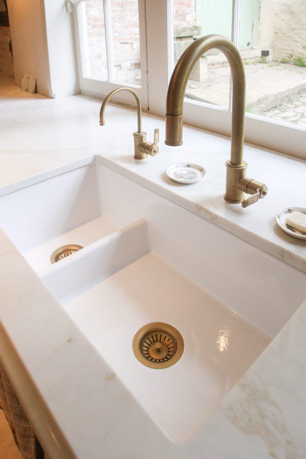 Supreme Calacatta Quartz worktop around a double bowl sink with polished white surface and subtle marble-effect veining