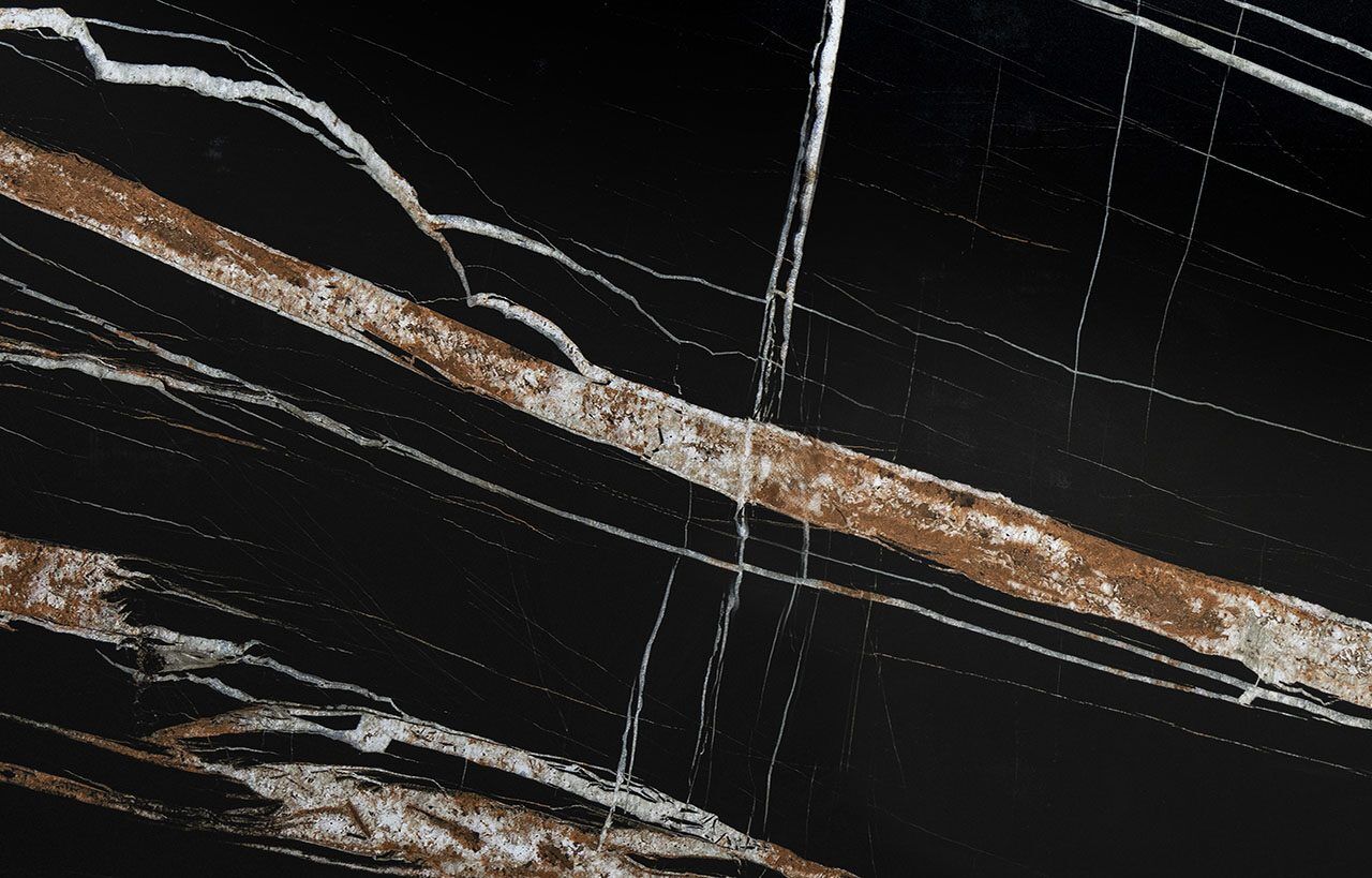 Noir St Laurent Porcelain worktop slab close up showing deep black surface with bold gold veining, styled with food and accessories
