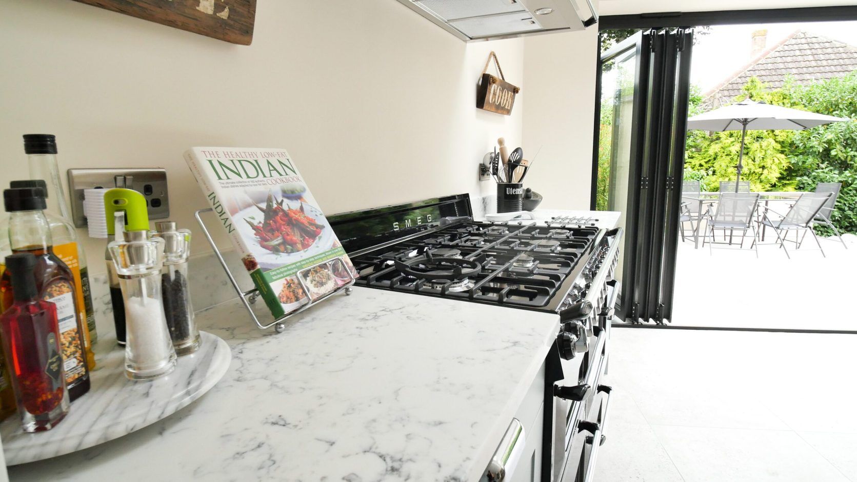 Arabescato Quartz worktop beside a range cooker, showing grey veining and a smooth white finish