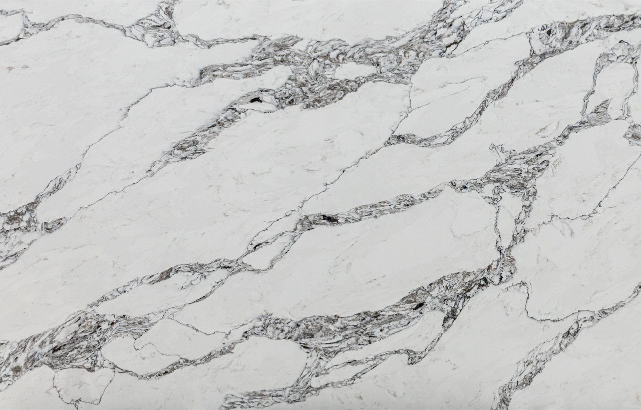 Ivory Calacatta Quartz slab close-up showing bold grey veining and marble-effect movement across a bright white base