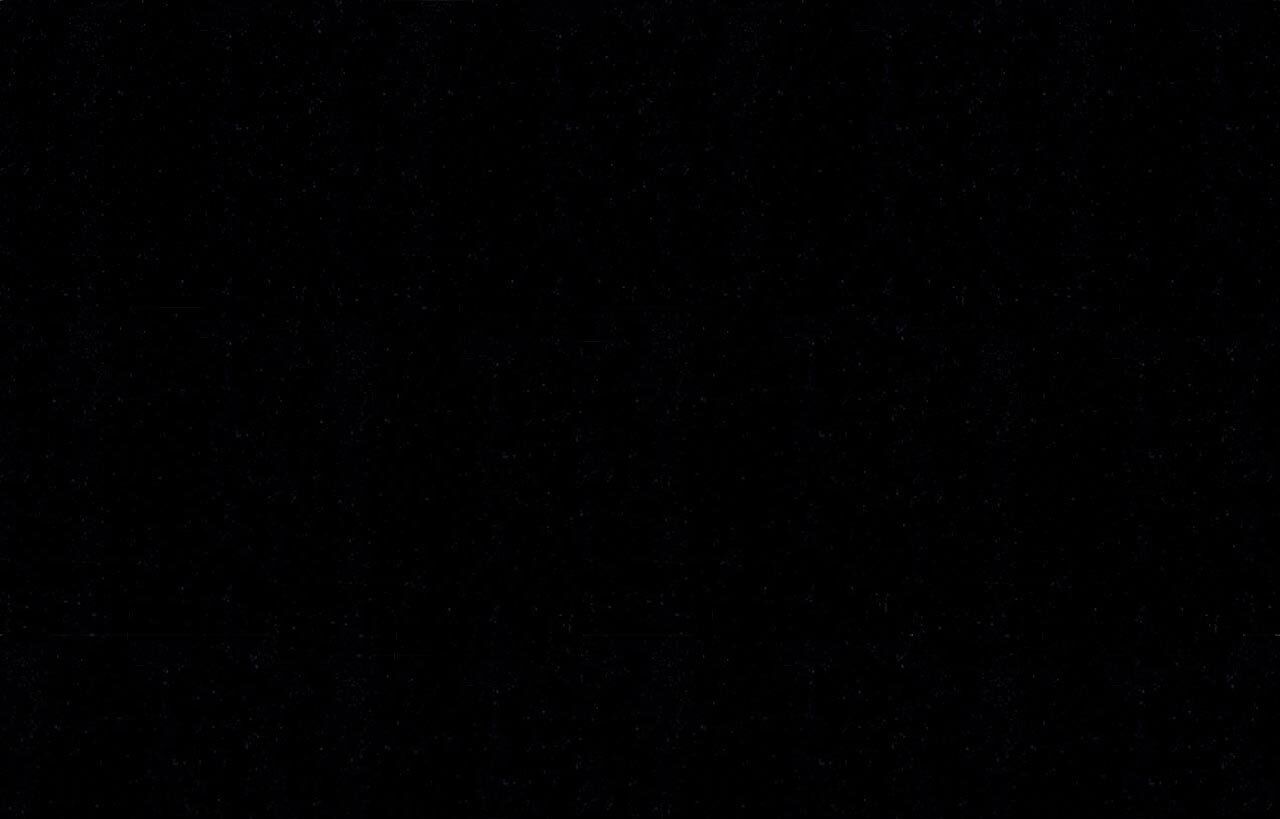 Close up of Absolute Black Granite worktop surface showing the consistent black colour and glossy polished texture.