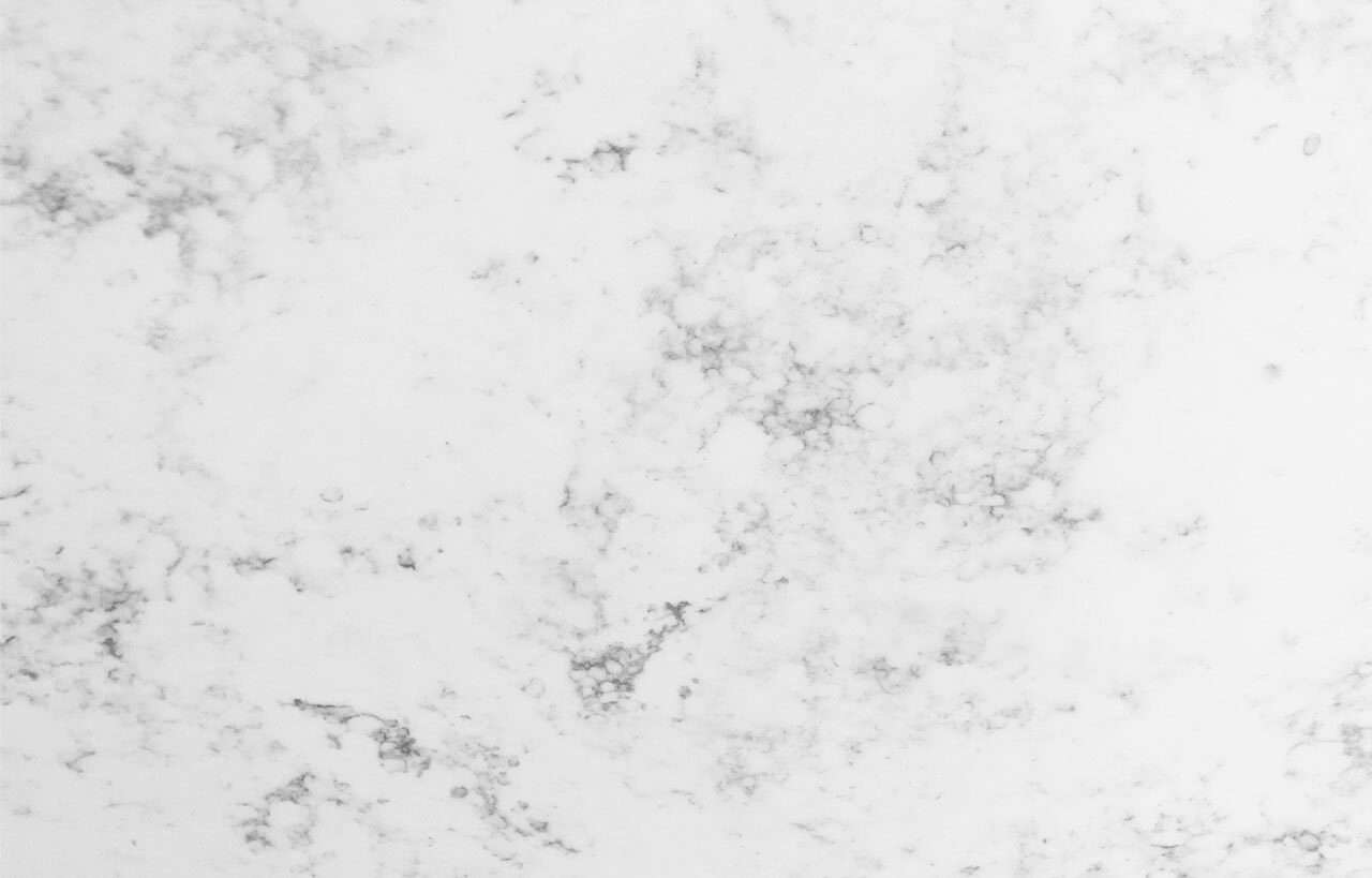 Close-up of Arabescato Quartz slab showing soft grey veining and a polished white finish