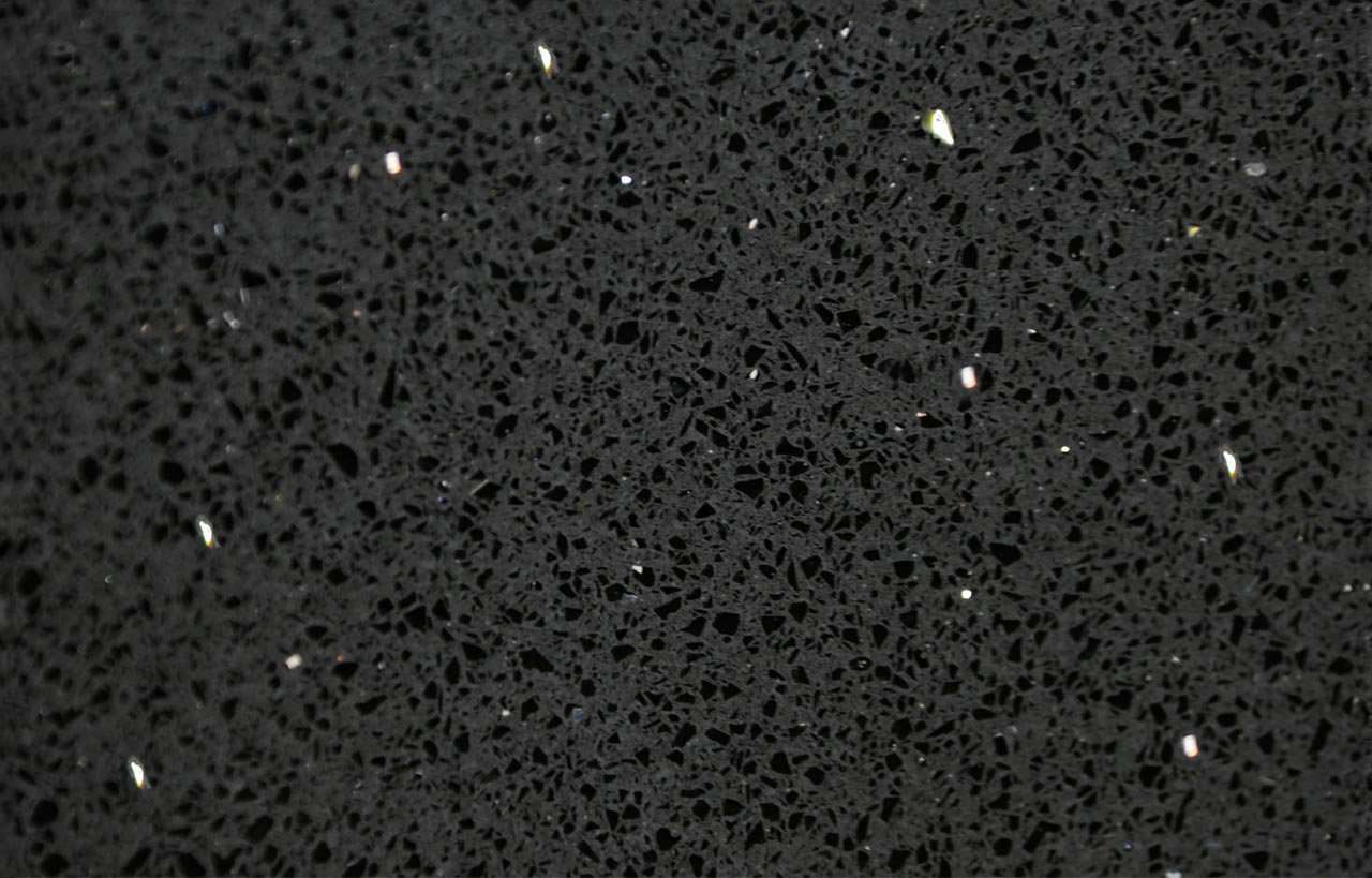 Close-up of Black Starlight Quartz slab showing fine speckled texture and reflective flecks in a black finish