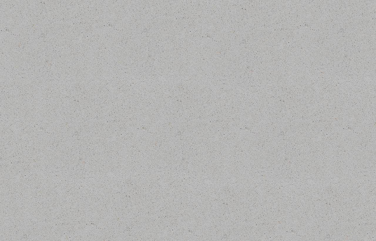 Carnie Quartz slab close-up showing fine speckle texture across a light grey surface