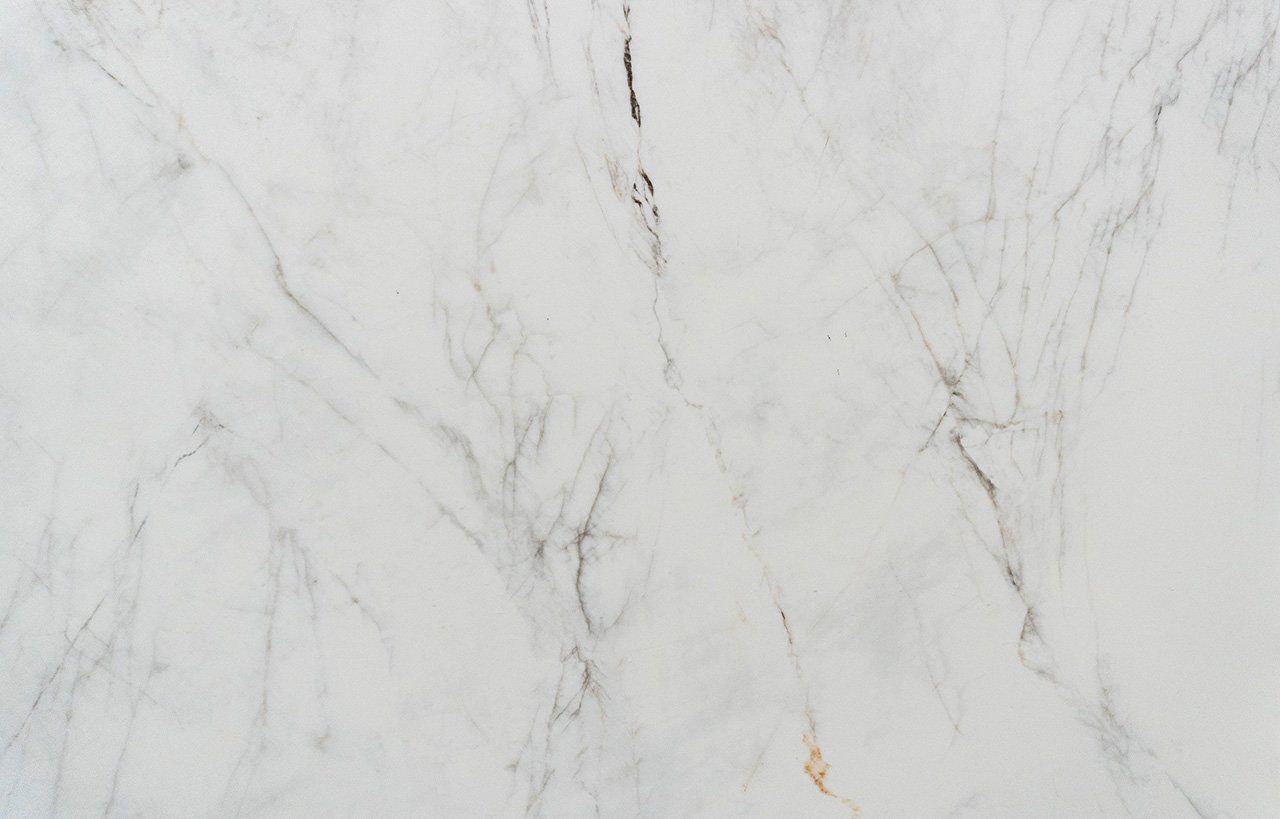 Carrara Venato Gold Porcelain slab view showing a light marble effect surface with fine grey veining and gentle gold accents