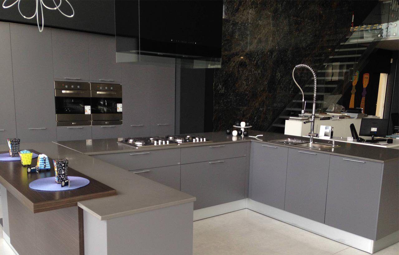 Cemento Spa Porcelain worktops in a modern kitchen with grey cabinetry and dark grey concrete-effect surfaces