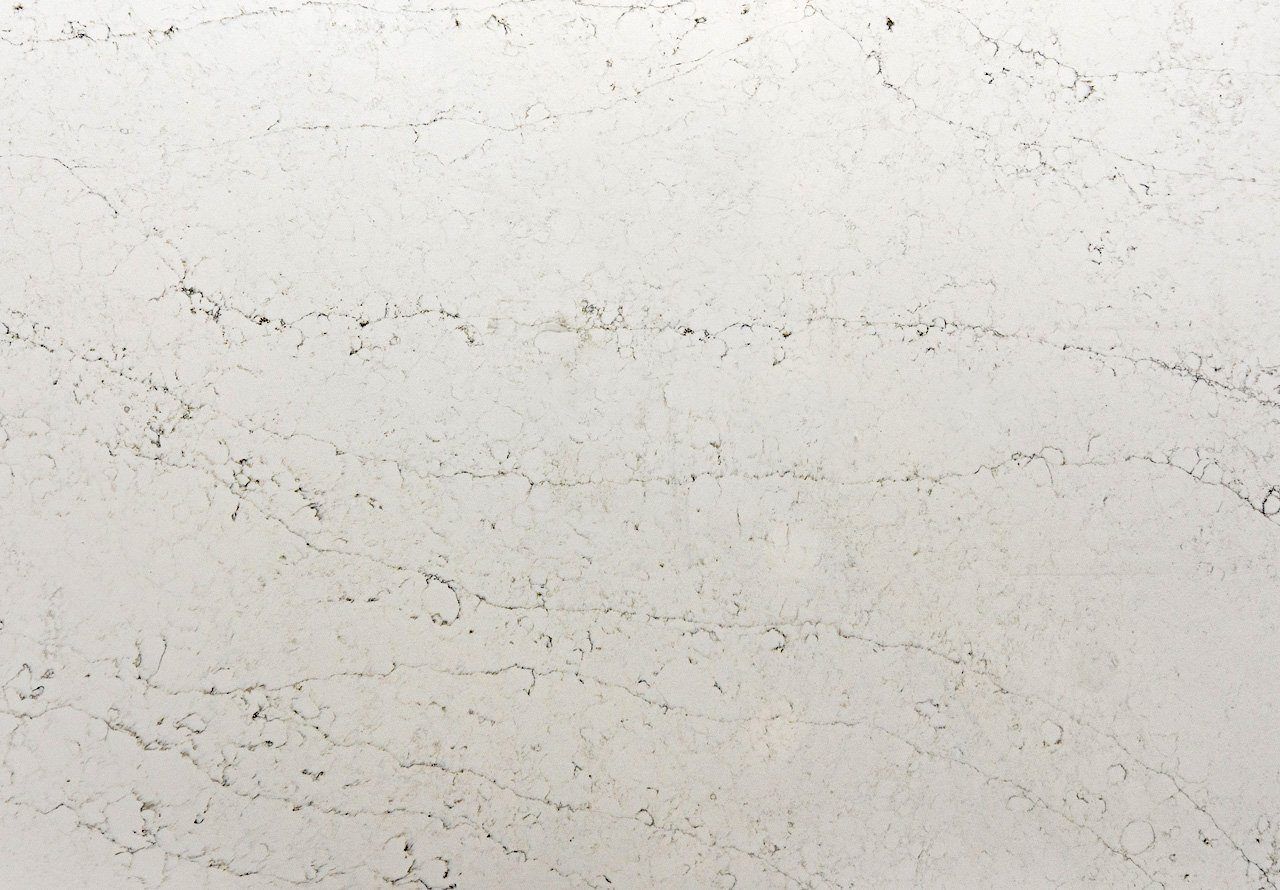 Eternal Carrara Quartz slab close-up showing layered grey veining and fine marble-effect lines across a pale background