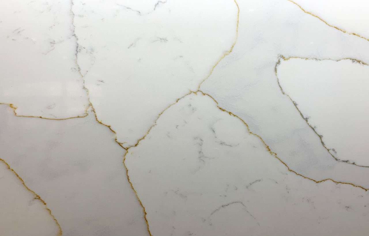 Close up of Gold Calacatta worktop surface showing warm natural veining