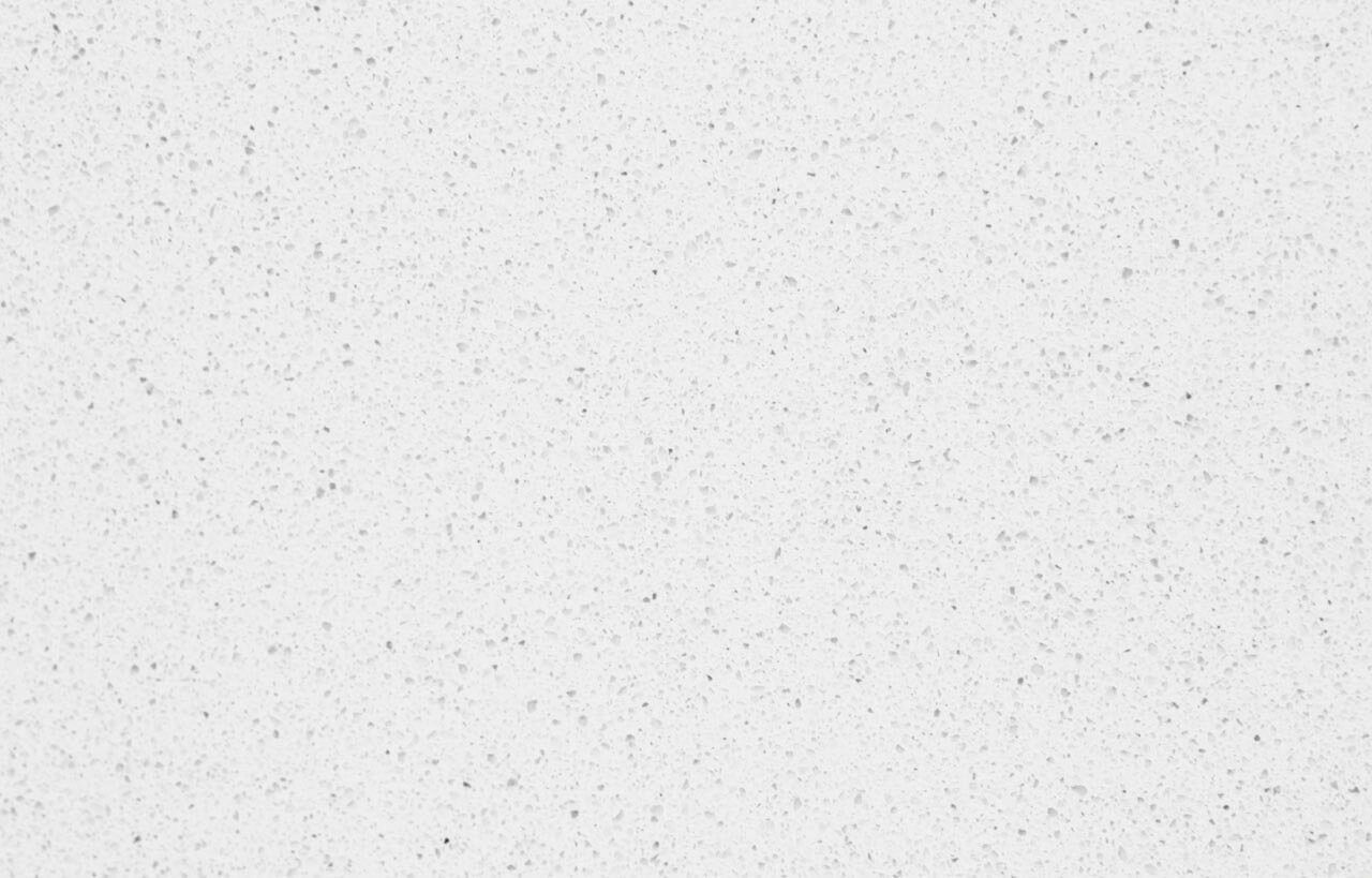 Close-up of a white Quartz surface showing fine speckling and a smooth, uniform finish