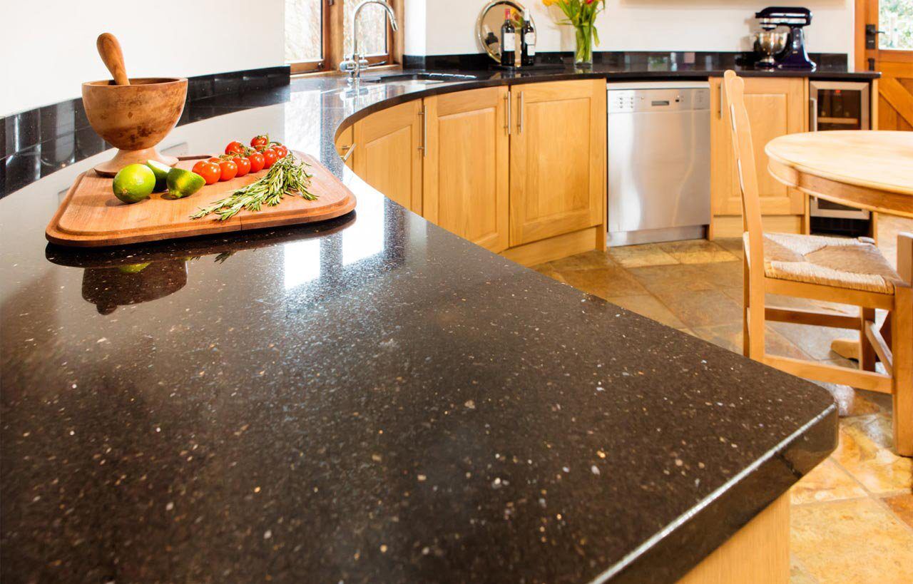 Curved kitchen worktop in Nero Cosmos Granite with a polished finish, showing the rounded edge detail and sparkling flecks under light.