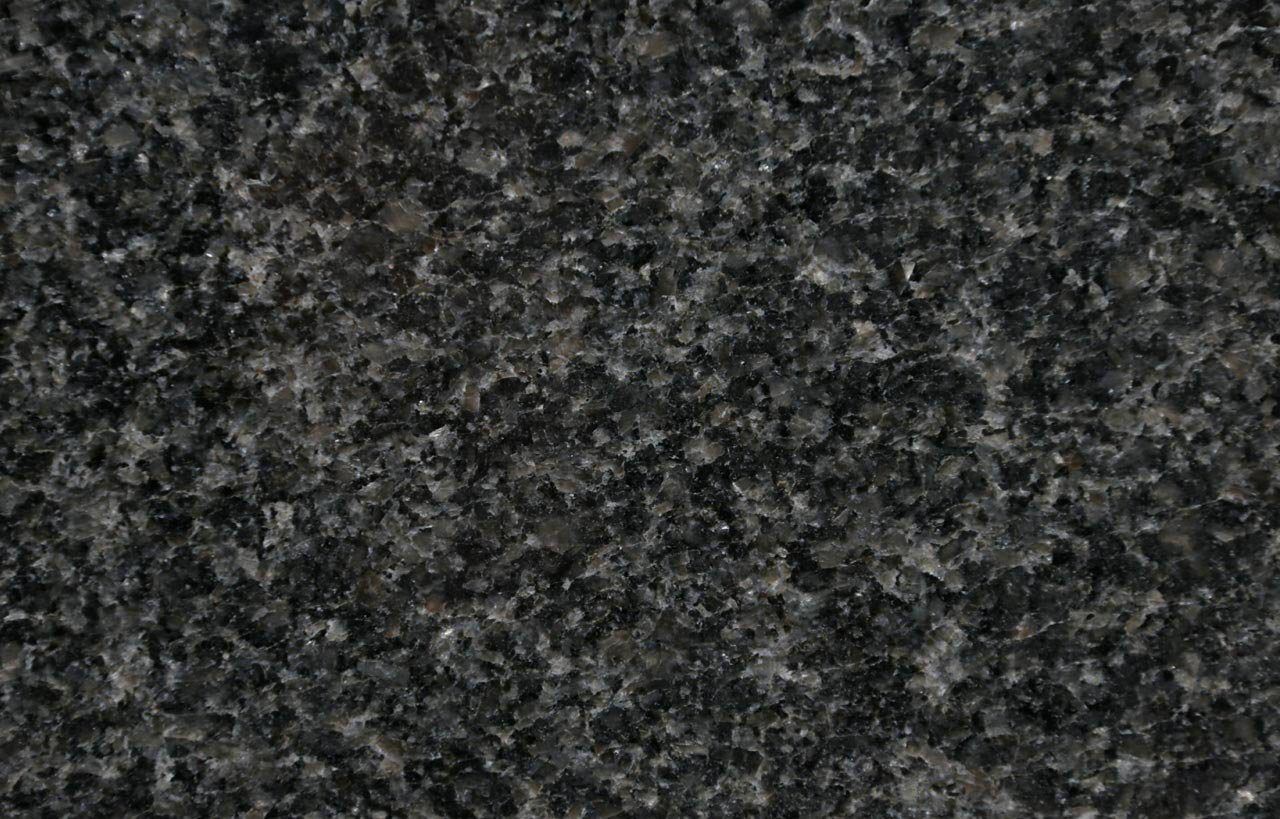 Close up slab photo of Nero Impala Granite showing a dense dark grey speckled pattern and fine grain across the surface.