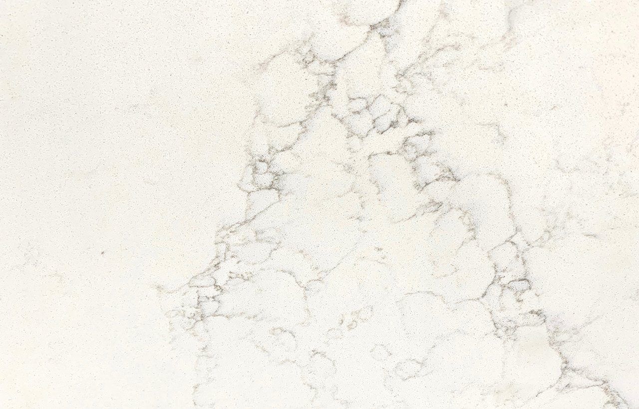 Close-up of Olympus White Quartz slab showing soft grey veining across a bright white surface