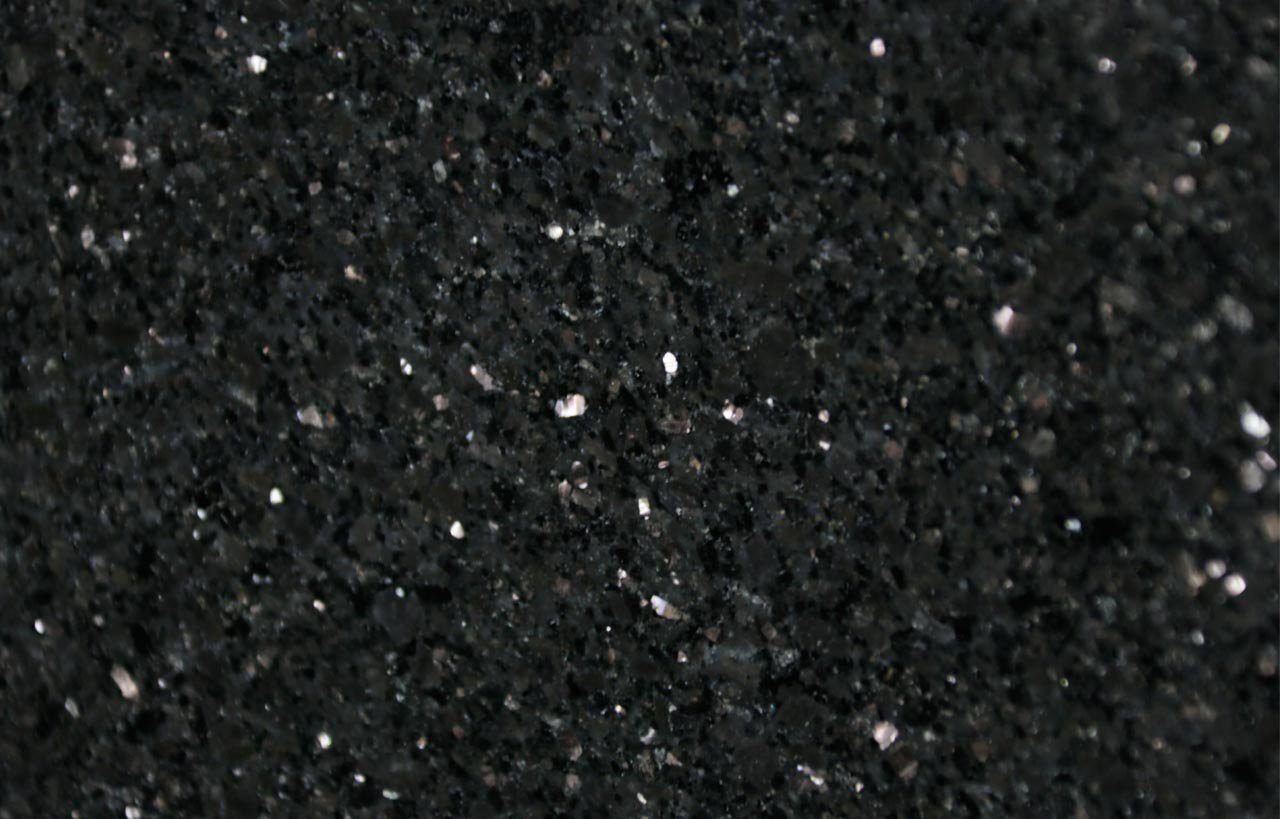 Close up slab photo of Star Galaxy Granite showing a deep black base with dense sparkling flecks and natural crystal patterning.