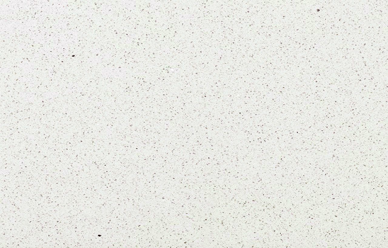 Stardust Quartz slab close-up showing white surface with fine speckled grain and subtle sparkle throughout
