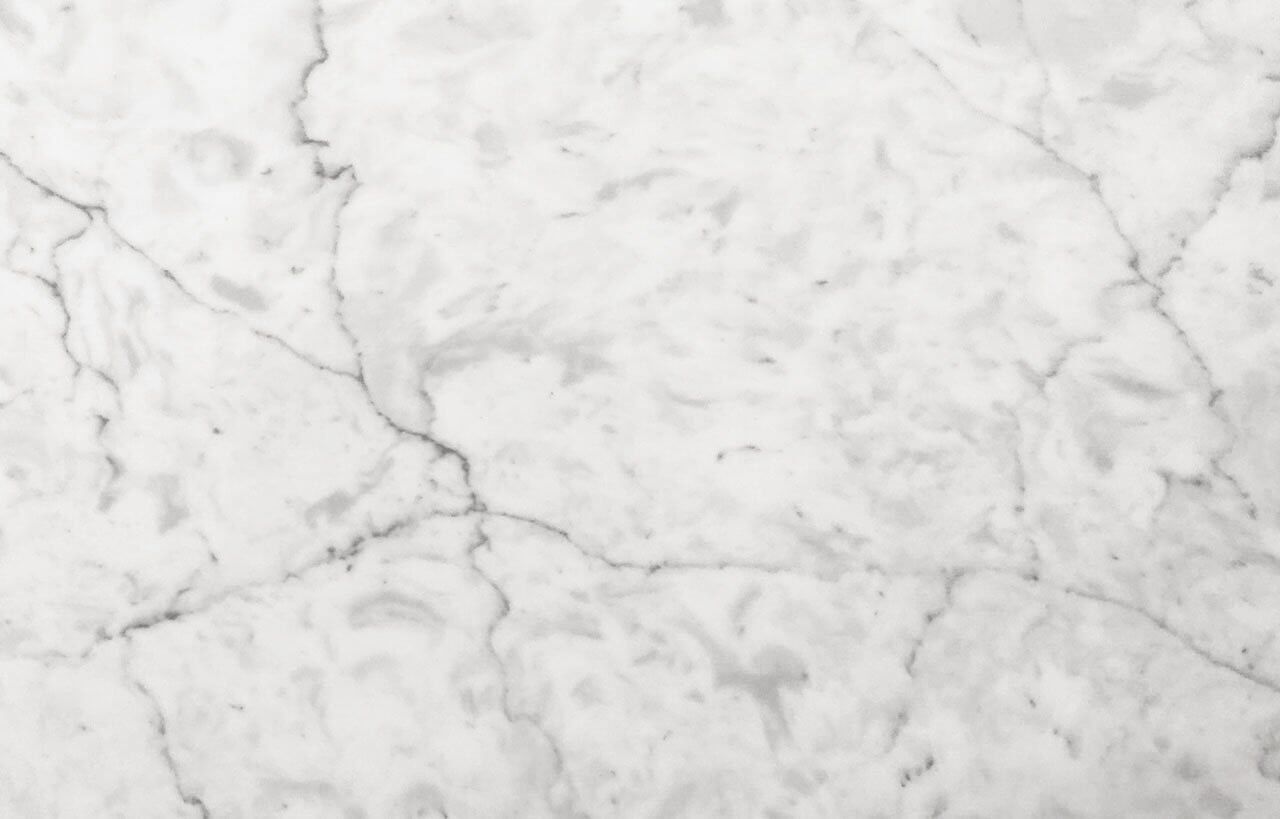 Super White Quartz close-up showing subtle grey veining and a smooth polished finish across the light surface