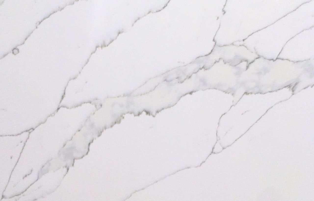 White Calacatta Quartz surface showing bold grey veining on a bright white background