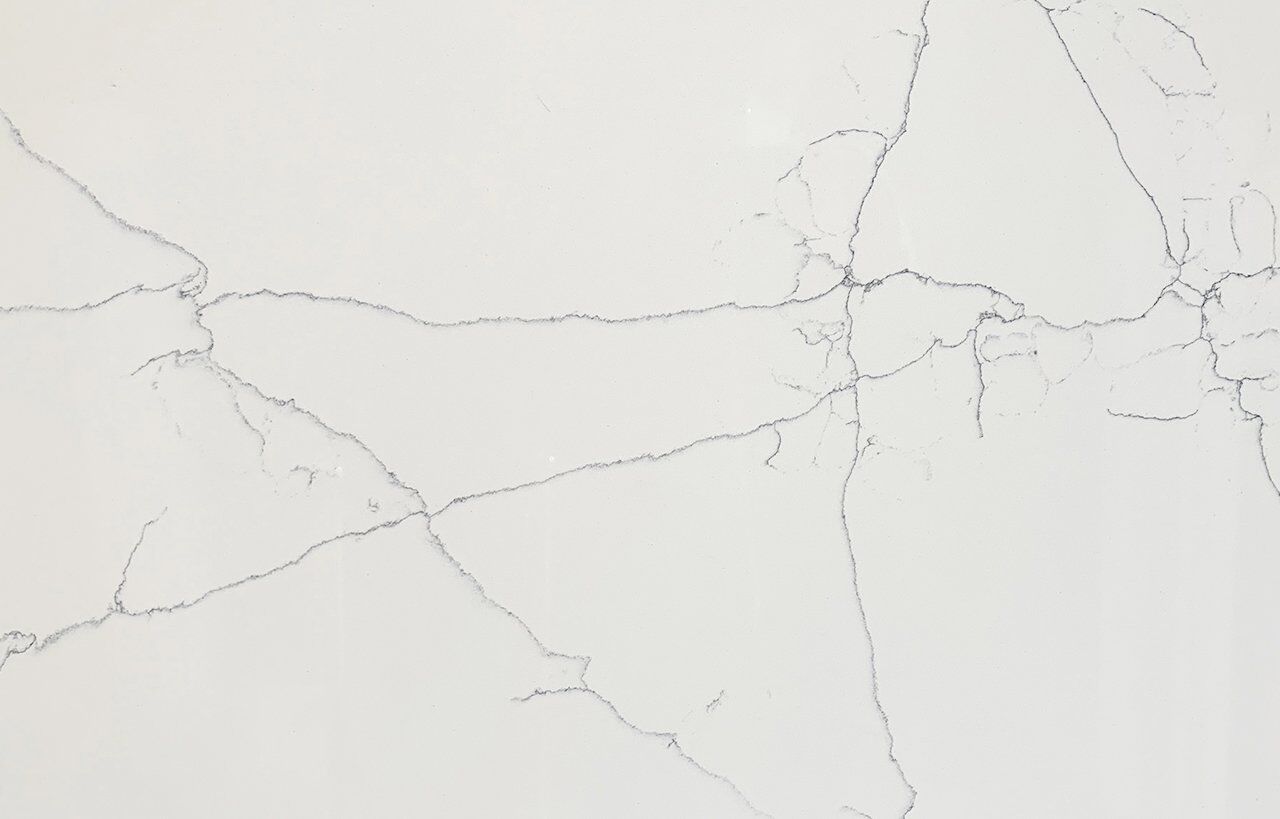 Close-up of White Macaubus Quartz showing fine grey veining across a bright white surface