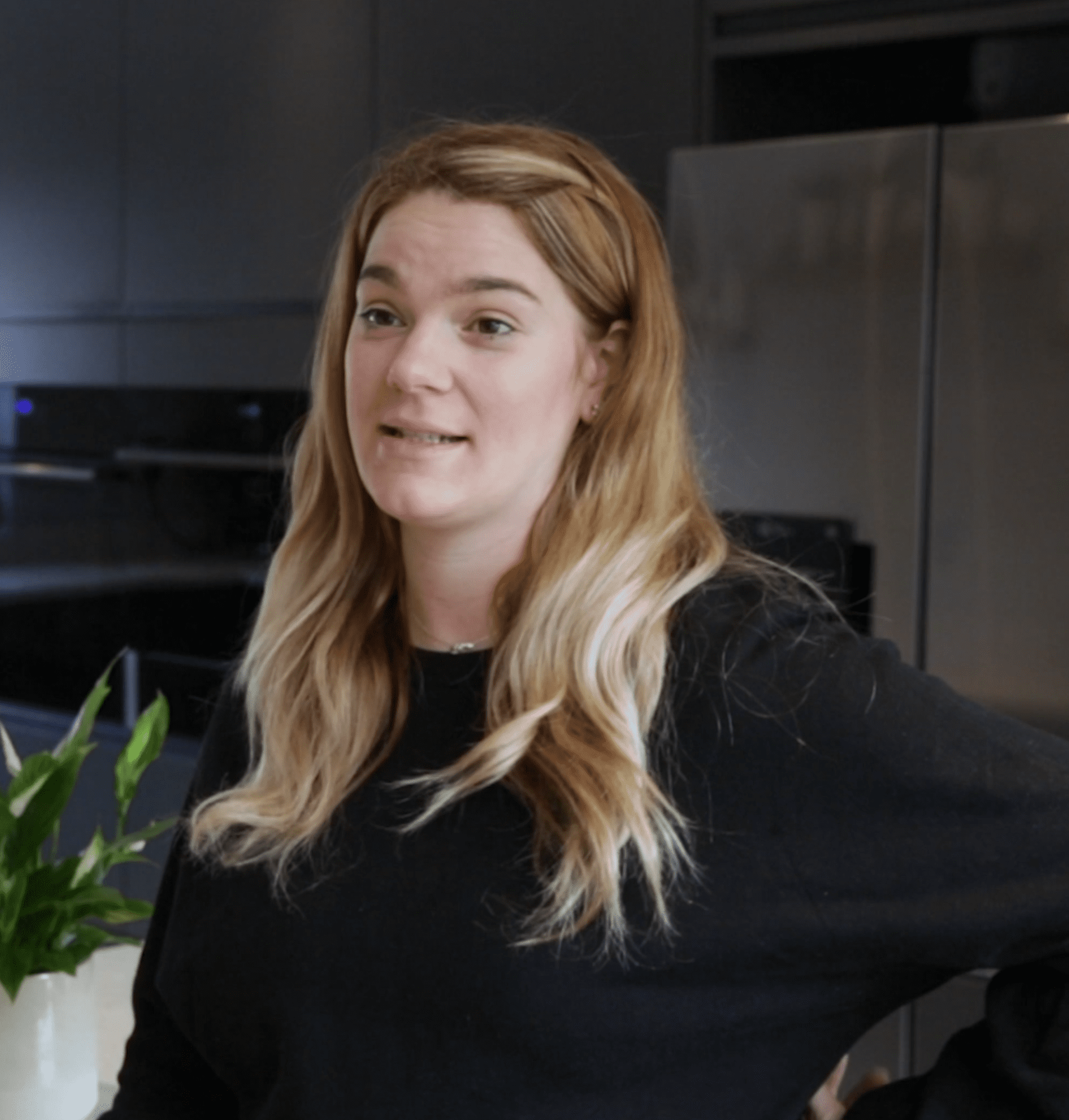 Megan testimonial kitchen featuring Grey Drift Quartz worktops in a modern space with dark cabinetry