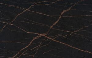 Laurent Porcelain surface detail showing dark porcelain with warm gold veining running diagonally across the worktop.