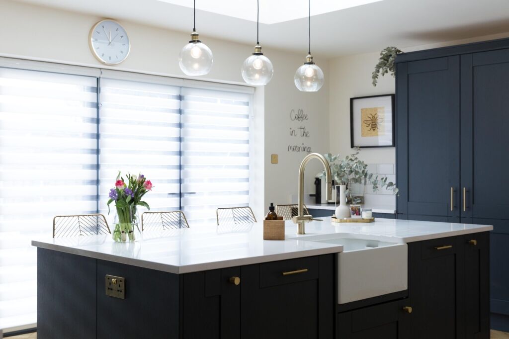 Blanco Zeus Quartz island worktop in a modern kitchen with a bright white surface and pendant lighting above